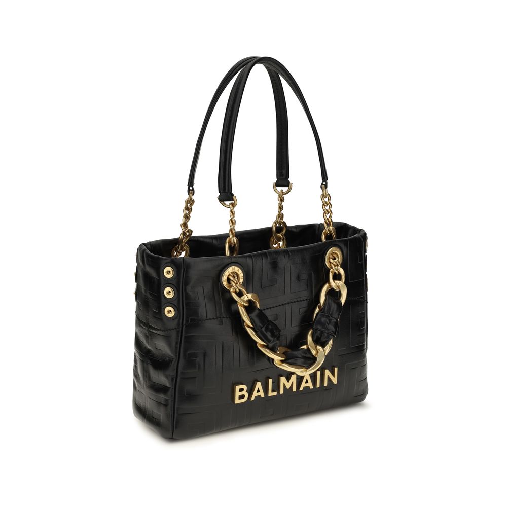 Schwarze Lederschultertasche mit goldfarbenen Beschlägen