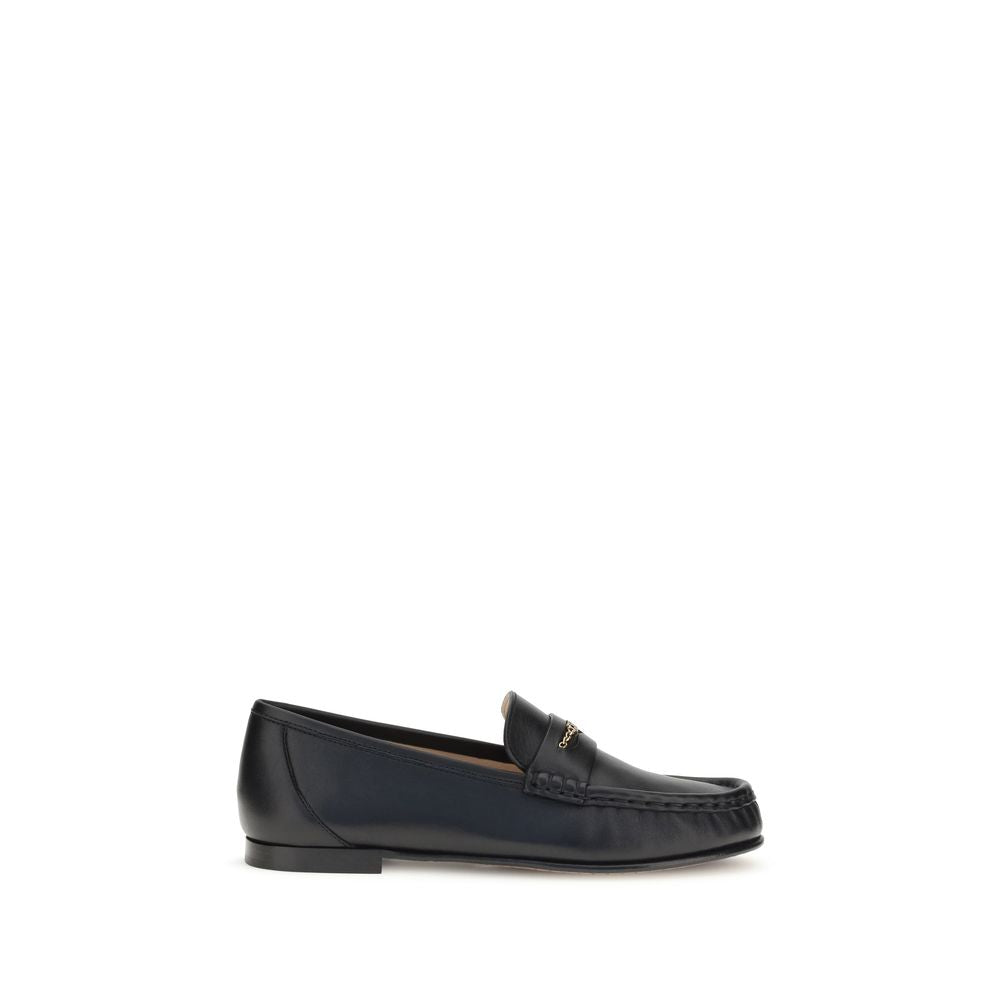 Schwarze Leder-Slipper mit goldener Kettenapplikation
