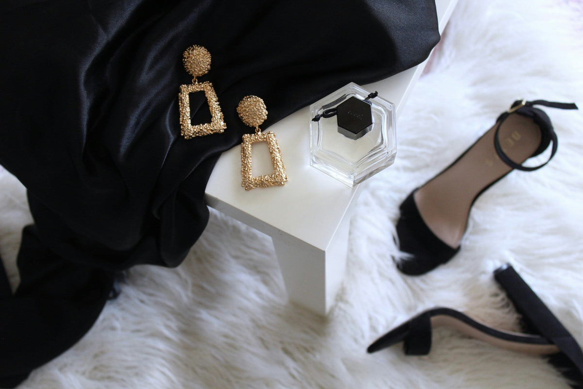 All-black outfit with a wool coat and leather boots