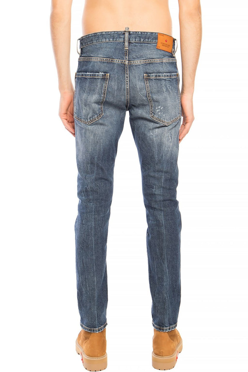 Blue Cotton Men JeansElevate your denim game with the distinctive flair of Dsquared²’s Navy ‘Cool Guy Jean’. These premium jeans boast a bold distressed design, ideal for the fashion-forward individual. Their tapered legs are finished with a raw edge, add
