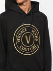Chic Black Hooded SweatshirtStep out in style with this absolutely stunning, 100% Authentic Versace Jeans hooded sweatshirt. A versatile piece that exudes casual luxury, perfect for those who appreciate high-fashion and comfort. The sleek black color and