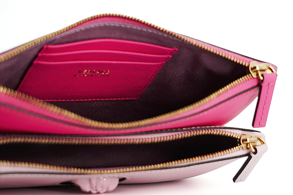 Elegant Pink Leather Pouch ClutchDrape yourself in luxury with this stunning new arrival from Versace. A perfect blend of fashion and functionality, this pouch clutch bag is crafted from the finest calf leather, boasting a rich pink hue that makes a bold