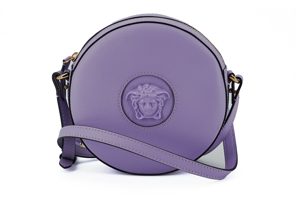 Elegant Purple Round Shoulder BagImmerse yourself in the epitome of elegance with this stunning Versace Disco Round Shoulder Bag. Brand new with tags, and accompanied by the original Versace dust bag, this accessory is crafted from the finest calf leather