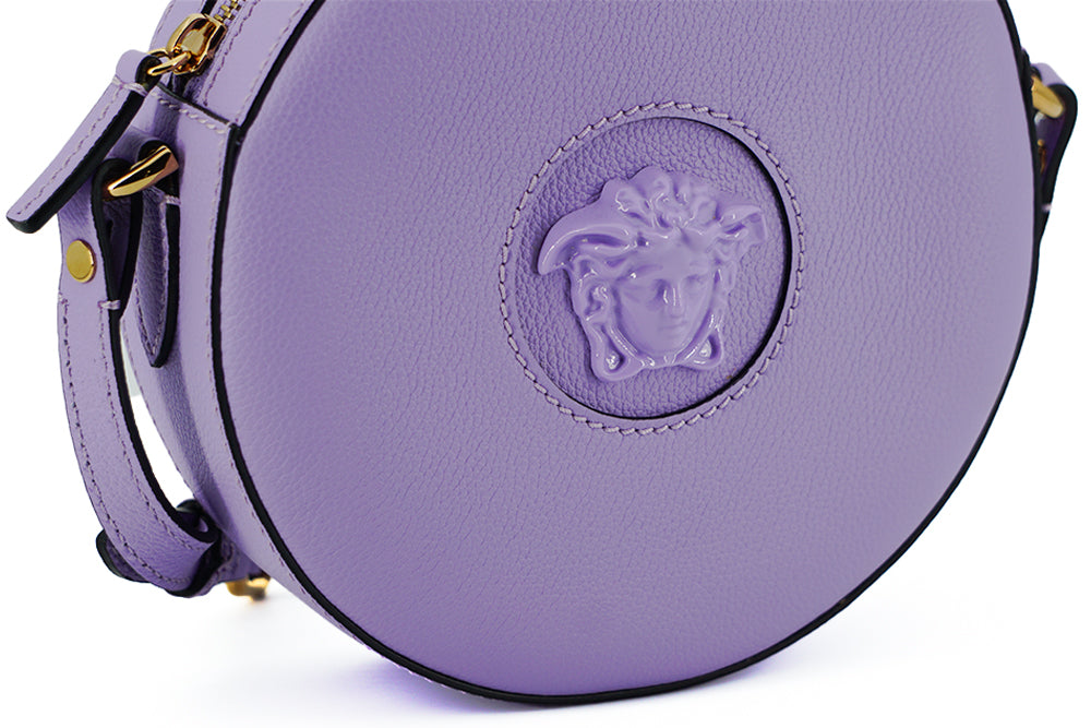 Elegant Purple Round Shoulder BagImmerse yourself in the epitome of elegance with this stunning Versace Disco Round Shoulder Bag. Brand new with tags, and accompanied by the original Versace dust bag, this accessory is crafted from the finest calf leather