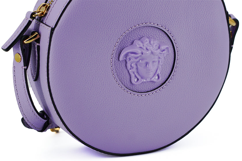 Elegant Purple Round Shoulder BagImmerse yourself in the epitome of elegance with this stunning Versace Disco Round Shoulder Bag. Brand new with tags, and accompanied by the original Versace dust bag, this accessory is crafted from the finest calf leather