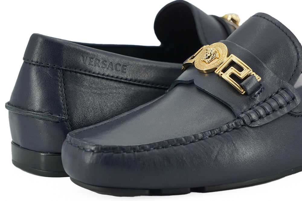 Elegant Navy Blue Calf Leather LoafersStep into luxury with these impeccable Versace men’s loafers, brand new and accompanied by the original box, tags, and a protective dust bag. Crafted from the finest 100% calf leather in a sophisticated navy blue, the