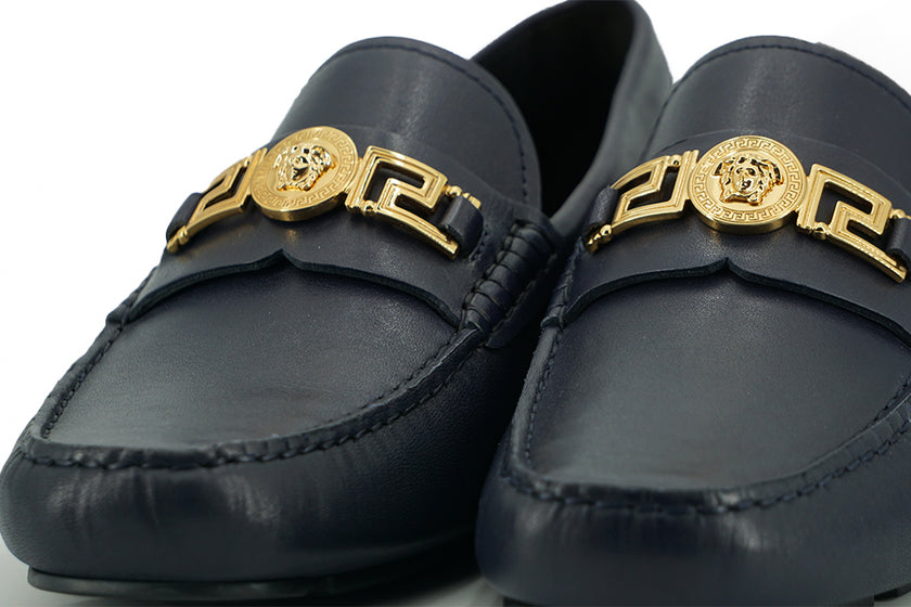 Elegant Navy Blue Calf Leather LoafersStep into luxury with these impeccable Versace men’s loafers, brand new and accompanied by the original box, tags, and a protective dust bag. Crafted from the finest 100% calf leather in a sophisticated navy blue, the