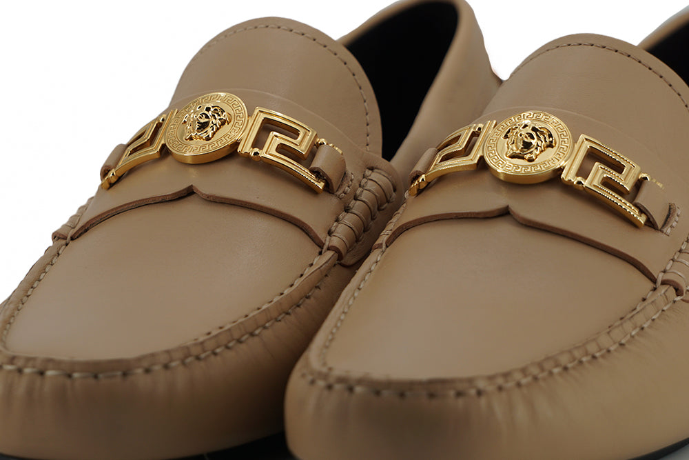 Exquisite Medusa Gold-Tone Leather LoafersIndulge in the epitome of luxury with these 100% authentic Versace men’s loafers, new with tags, box, and dust bag included. Crafted from the finest calf leather in an elegant beige hue, these shoes are the perfec