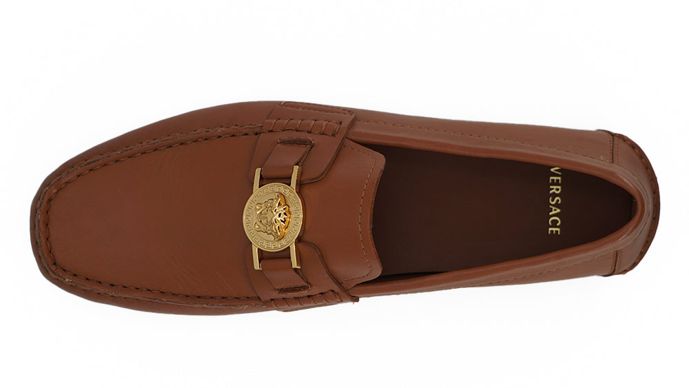 Elegant Medusa-Embossed Leather LoafersEmbrace sophistication with these 100% authentic Versace men’s loafers, perfect for the discerning gentleman. Arriving in pristine condition with original box, tags, and dust bag, these shoes not only promise unparal