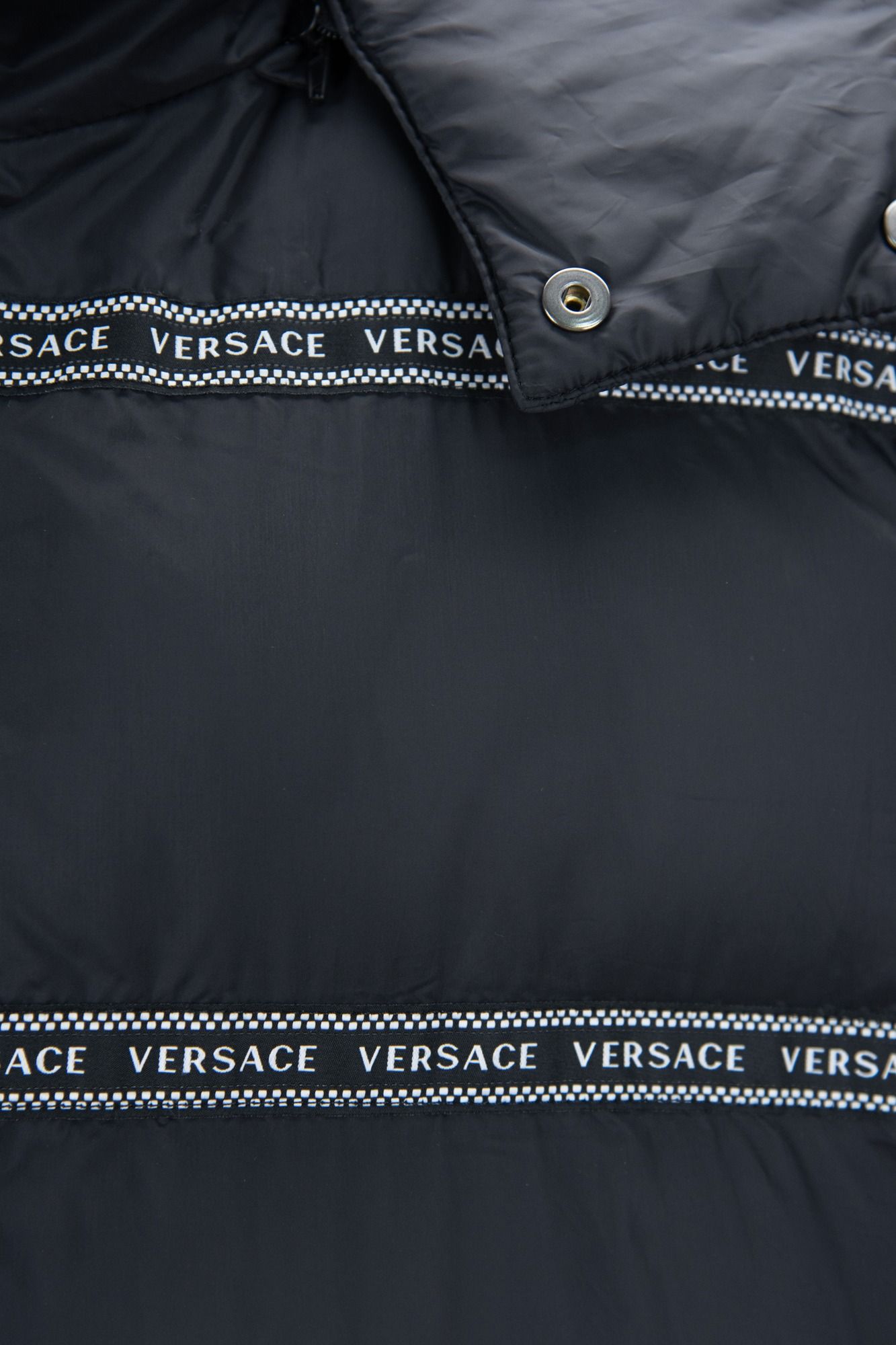 Elegant Black Logo Band Vest with Detachable HoodStep up your style game with this stunning new arrival from Versace. This sleek black vest boasts a striking design with white ‘Versace’ logo bands that add an edge to any outfit. Featuring a versatile hood
