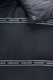 Elegant Black Logo Band Vest with Detachable HoodStep up your style game with this stunning new arrival from Versace. This sleek black vest boasts a striking design with white ‘Versace’ logo bands that add an edge to any outfit. Featuring a versatile hood