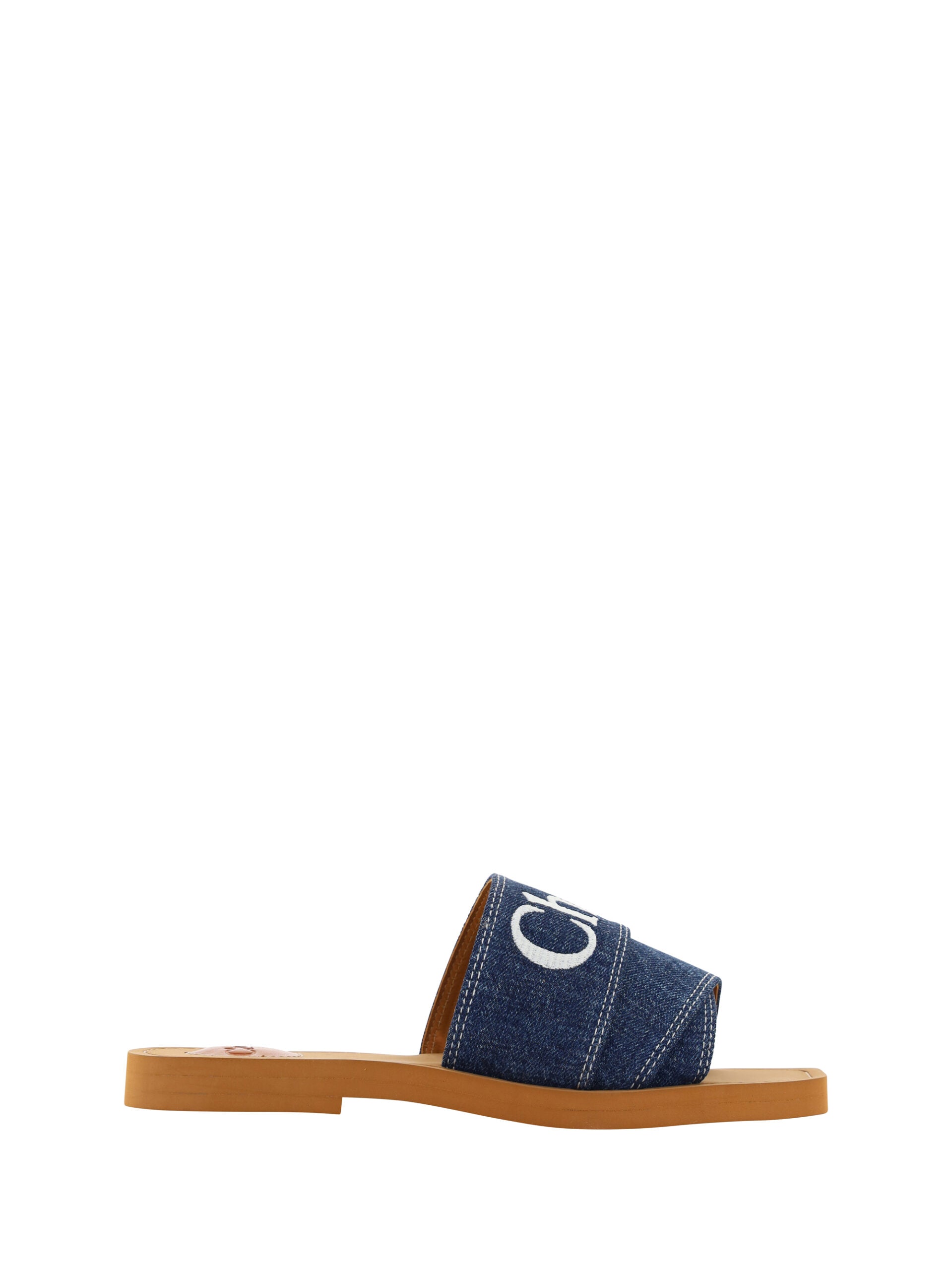 Sumptuous Cotton Woody Slide Sandals in Denim BlueIndulge in the essence of summer luxury with our exquisite Chloé Woody Slide Sandals. These 100% authentic sandals are the perfect blend of comfort and style, designed for the discerning woman. Crafted wit