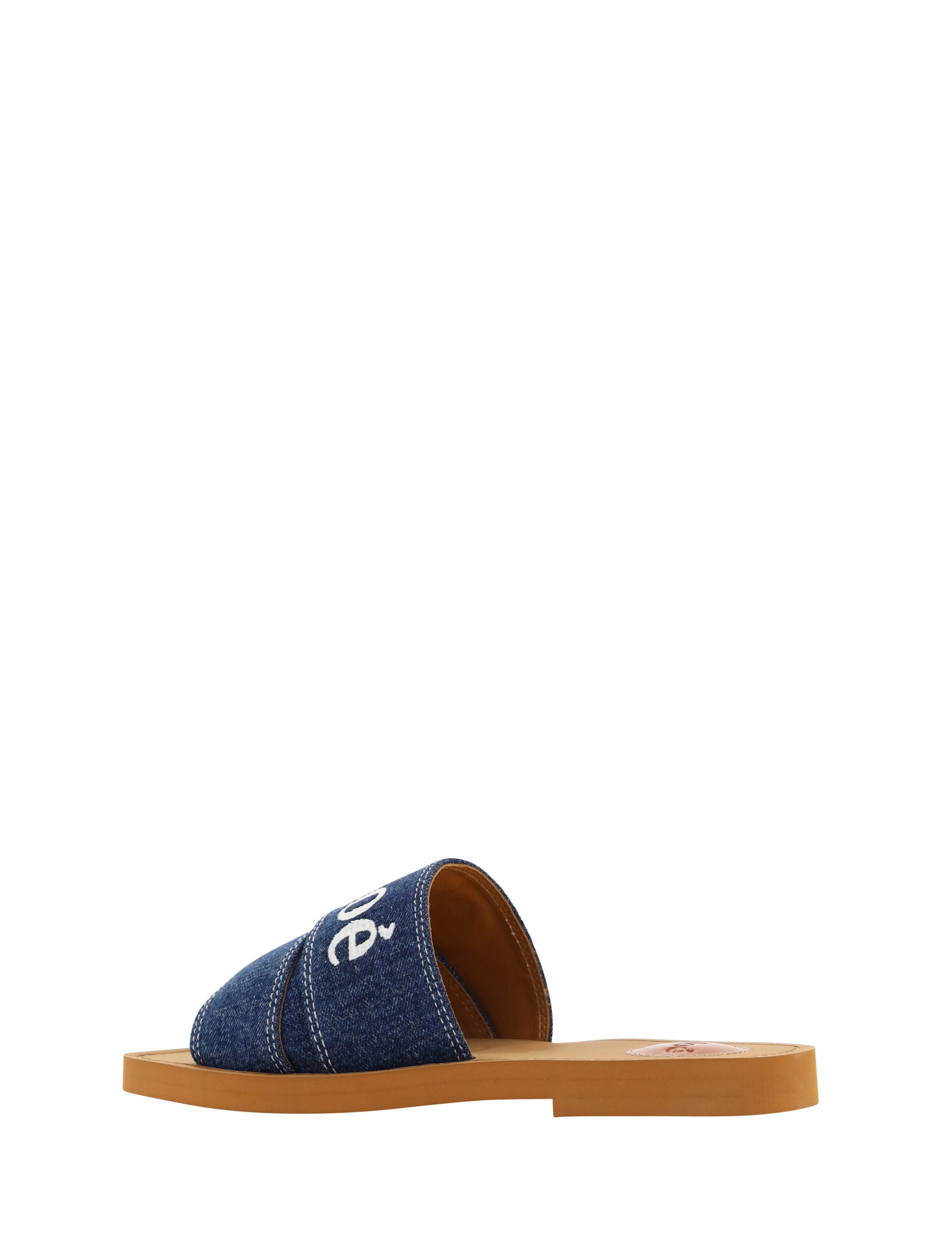 Sumptuous Cotton Woody Slide Sandals in Denim BlueIndulge in the essence of summer luxury with our exquisite Chloé Woody Slide Sandals. These 100% authentic sandals are the perfect blend of comfort and style, designed for the discerning woman. Crafted wit