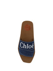 Sumptuous Cotton Woody Slide Sandals in Denim BlueIndulge in the essence of summer luxury with our exquisite Chloé Woody Slide Sandals. These 100% authentic sandals are the perfect blend of comfort and style, designed for the discerning woman. Crafted wit