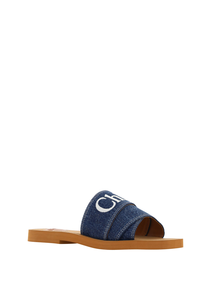 Sumptuous Cotton Woody Slide Sandals in Denim BlueIndulge in the essence of summer luxury with our exquisite Chloé Woody Slide Sandals. These 100% authentic sandals are the perfect blend of comfort and style, designed for the discerning woman. Crafted wit
