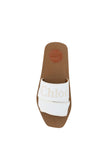 Elegant White Cotton Slide SandalsIndulge in the luxurious comfort of Chloé’s elegant slides. These sophisticated sandals are a testament to timeless style with a contemporary edge. Boasting a chic Snow White hue, they’re the perfect addition to your summ