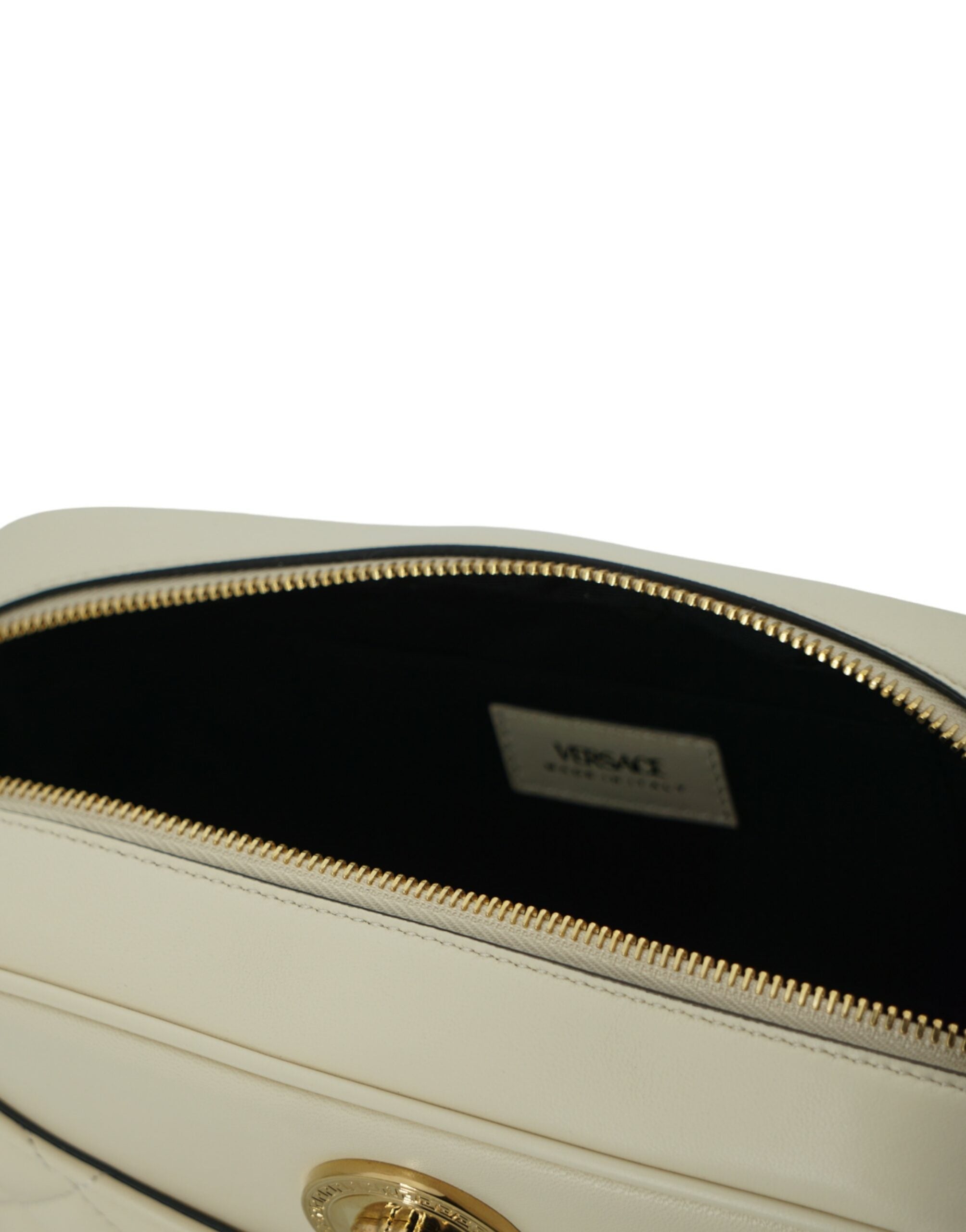 Elegant White Leather Camera Shoulder BagIndulge in the luxury of Versace with this exquisite camera shoulder bag, perfect for the fashion-forward individual. Crafted from the finest lamb leather, this white medium-sized bag exemplifies sophistication and