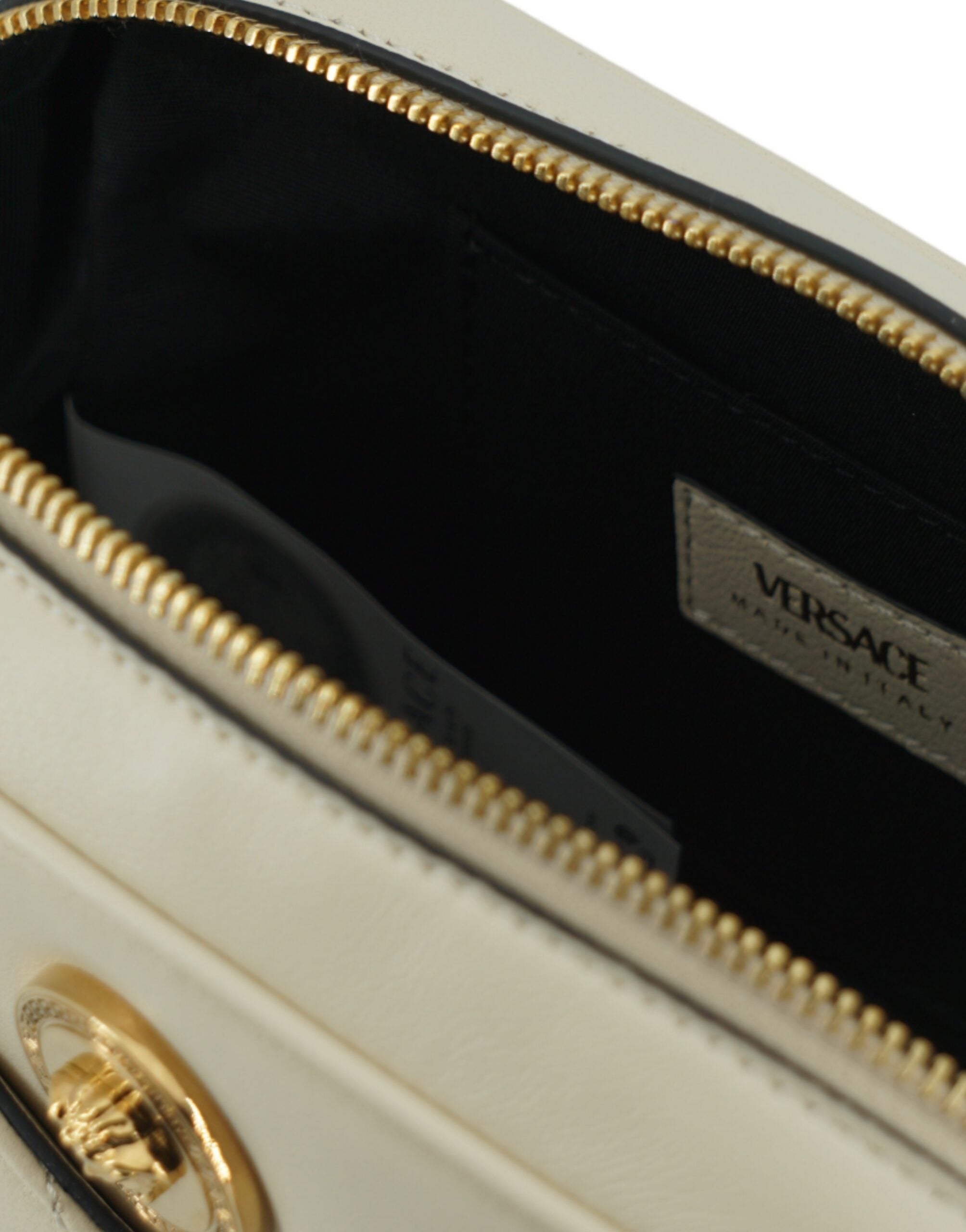 Elegant White Lamb Leather Camera BagIndulge in the elegance of the Versace Camera Crossbody Bag, crafted for those who appreciate luxury and style. This stunning accessory is your perfect companion for any occasion, blending fashion and functionality sea