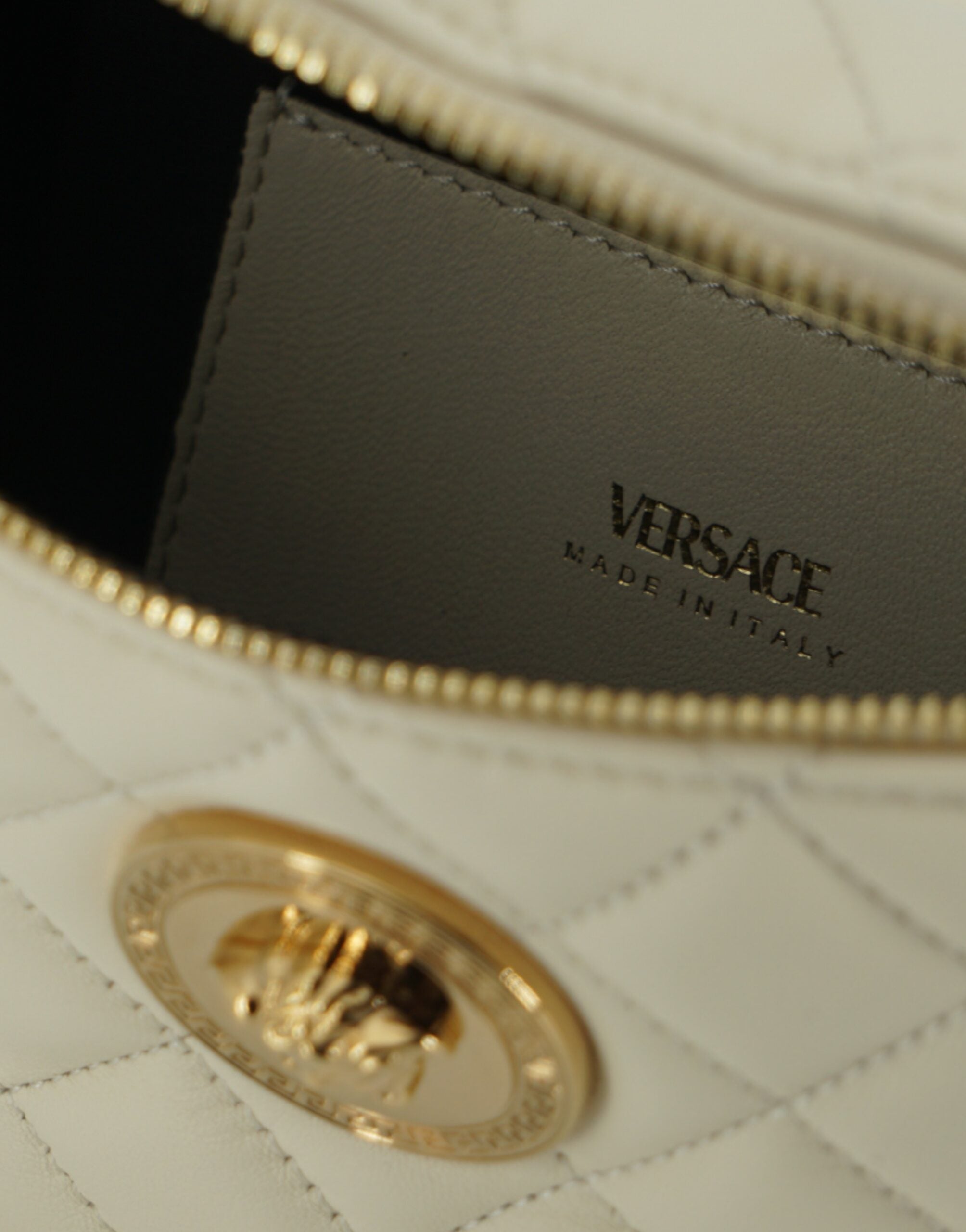 Elegant White Lamb Leather Belt BagIndulge in the epitome of luxury with this pristine white Belt Bag, a masterpiece from the renowned house of Versace. Expertly crafted from sumptuous 100% lamb leather, this brand new accessory is accompanied by tags and