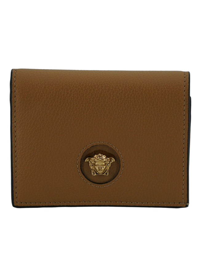 Elegant Compact Leather Wallet in BrownIndulge in the luxury of a Versace compact wallet, a sophisticated accessory that blends functionality with high fashion. Known for its exquisite Italian craftsmanship, this compact wallet is perfect for the chic ind