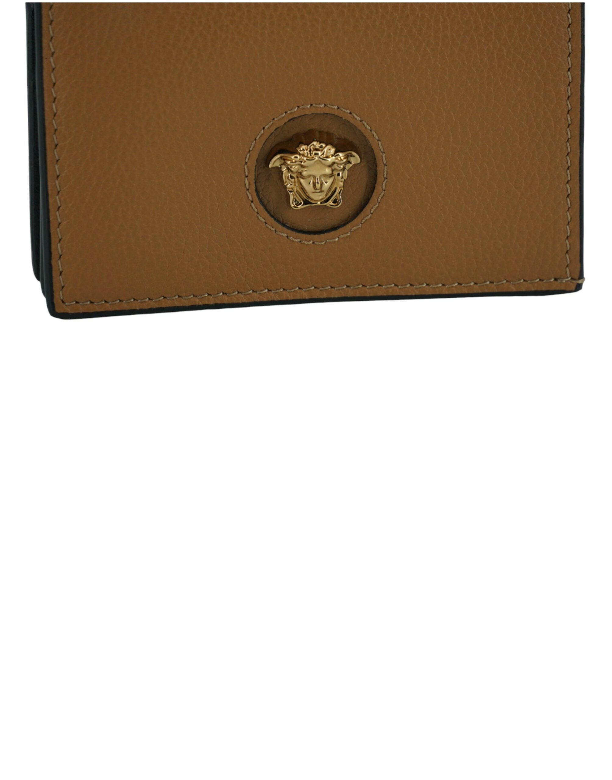 Elegant Compact Leather Wallet in BrownIndulge in the luxury of a Versace compact wallet, a sophisticated accessory that blends functionality with high fashion. Known for its exquisite Italian craftsmanship, this compact wallet is perfect for the chic ind