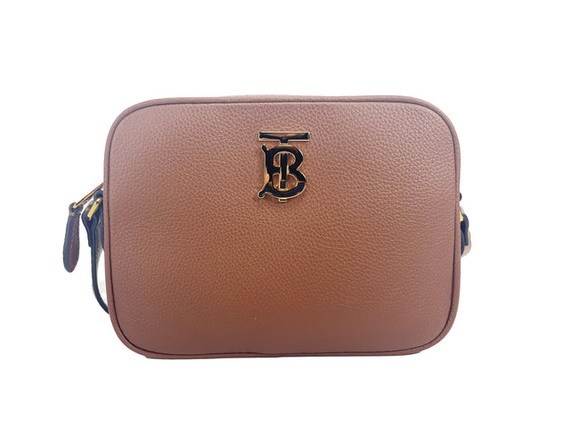 Small Leather Tan Camera Crossbody TB Logo BagStyle: Burberry Small Camera TB Logo Bag Crossbody (Tan) Material: Leather Features: Adjustable Crossbody Strap, Nylon Lined, Inner Slip Pocket, Gold Tone hardware Measures: 19cm L x 14cm H x 5cm DSmall Leathe