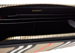 Ellerby Black Leather Icon Stripe Canvas Zip Around Continental WalletStyle: Burberry Ellerby Black Icon Stripe Zip Around Continental Wallet Material: Leather and Canvas Features: 6 Card Slots, Inner Zip Compartment, Bill Slots, Zip Around Closure Measur