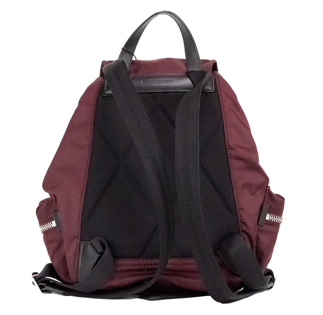 Medium Burgundy Econyl Nylon Rucksack Drawstring Backpack BookbagStyle: Burberry Medium Drawstring Flap Rucksack Bag (Burgundy) Material: Nylon (Burberry Econyl) Features: Drawstring Flap Closure, Adjustable Shoulder Straps, Top Handle, Outer Zip Pockets
