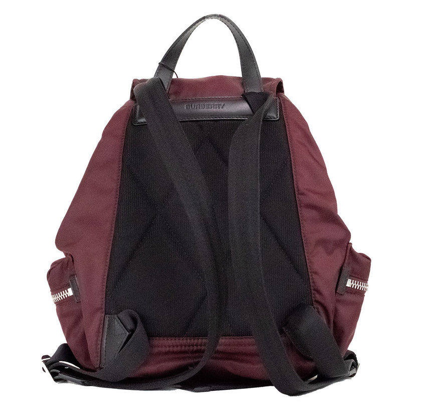 Medium Burgundy Econyl Nylon Rucksack Drawstring Backpack BookbagStyle: Burberry Medium Drawstring Flap Rucksack Bag (Burgundy) Material: Nylon (Burberry Econyl) Features: Drawstring Flap Closure, Adjustable Shoulder Straps, Top Handle, Outer Zip Pockets