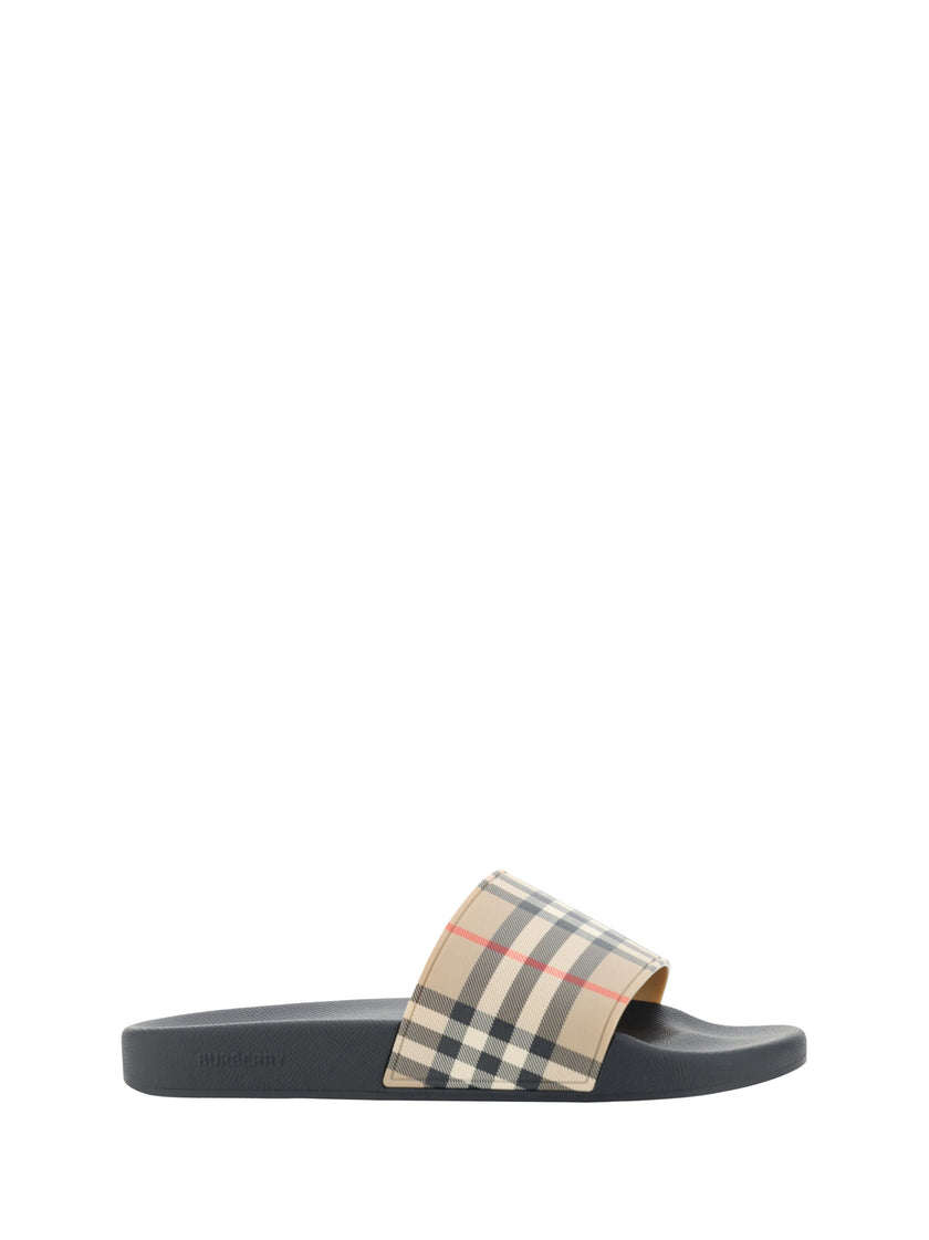 Brown Rubber Slides SandalsSandals by Burberry, wide front strap with the brand’s iconic Archivio Check pattern, flat sole, round toe, logo-embossed insole. Model: 8056942_A7028 Color: Archive Beige Brown Material: Rubber 100% Polyurethane 100% Season: SS