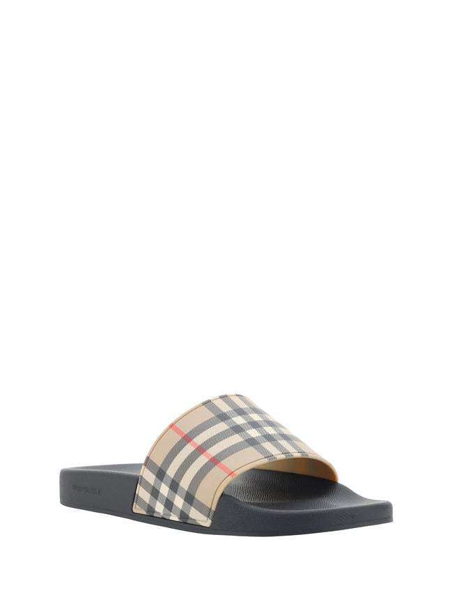 Brown Rubber Slides SandalsSandals by Burberry, wide front strap with the brand’s iconic Archivio Check pattern, flat sole, round toe, logo-embossed insole. Model: 8056942_A7028 Color: Archive Beige Brown Material: Rubber 100% Polyurethane 100% Season: SS