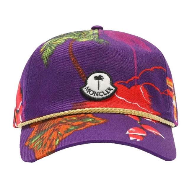 Purple Cotton Men CapElevate your headwear collection with the Moncler x Palm Angels baseball cap, where high fashion meets streetwear cool. This cap boasts a vivid floral print set against a rich purple backdrop that makes a bold statement. Adorned with