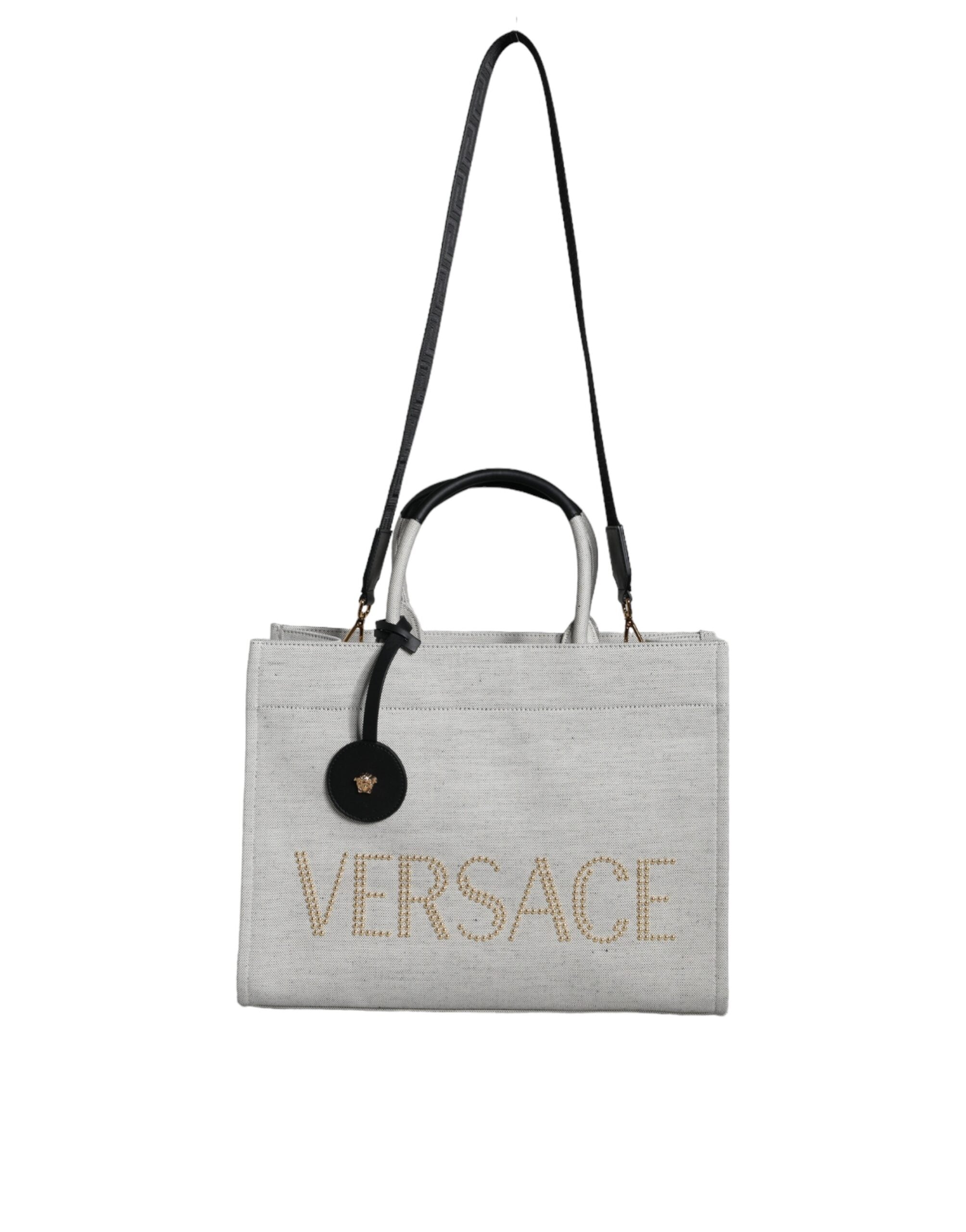 White Top Handle Canvas Leather Logo Crossbody Tote BagVERSACE Absolutely stunning, 100% Authentic, brand new with tags VERSACE tote bags. Brand logo, solid color, crossbody strap. Model: Tote bag Material: VL100%, WV66% VI19% PA10% WS5% Color: White, Bla