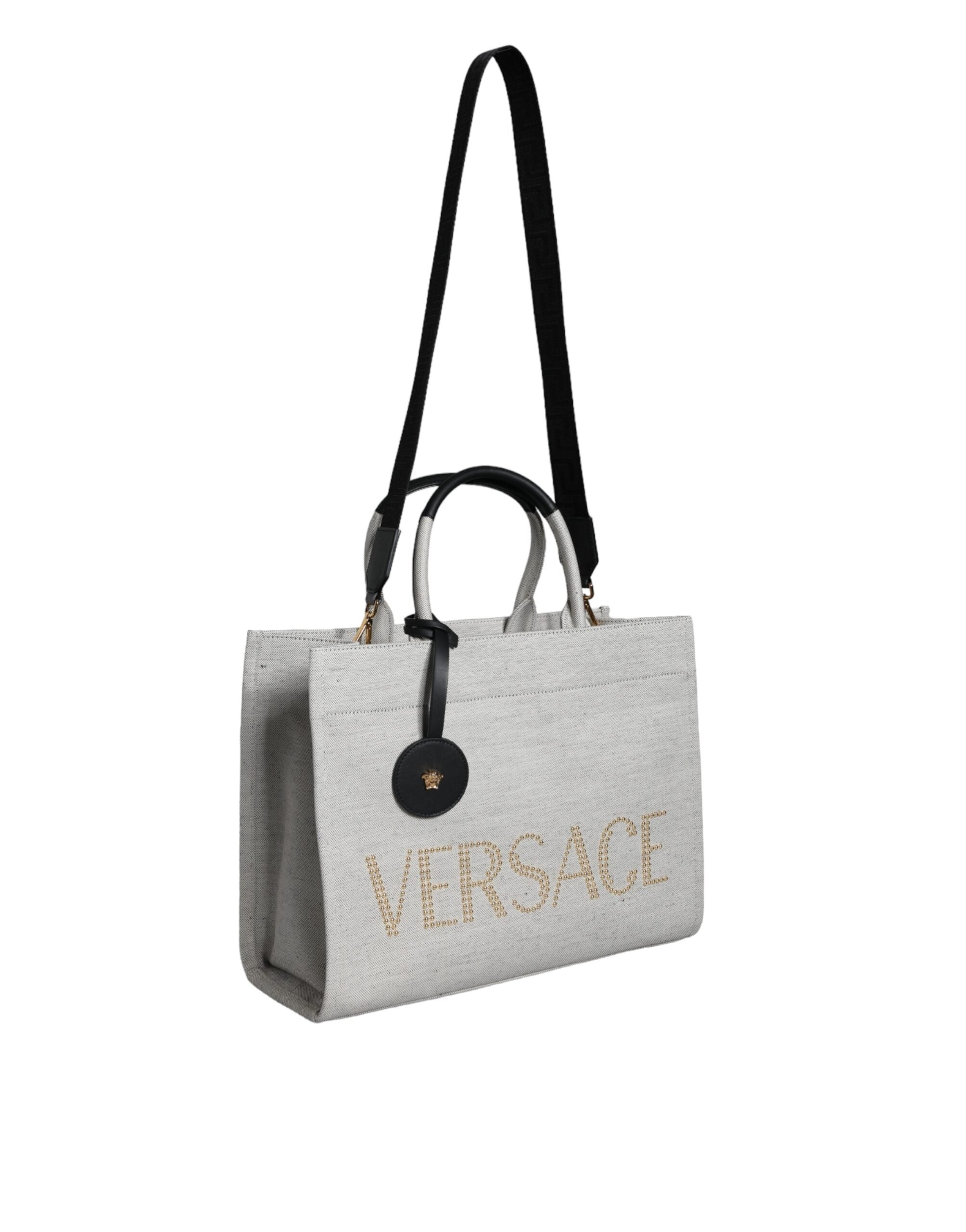 White Top Handle Canvas Leather Logo Crossbody Tote BagVERSACE Absolutely stunning, 100% Authentic, brand new with tags VERSACE tote bags. Brand logo, solid color, crossbody strap. Model: Tote bag Material: VL100%, WV66% VI19% PA10% WS5% Color: White, Bla