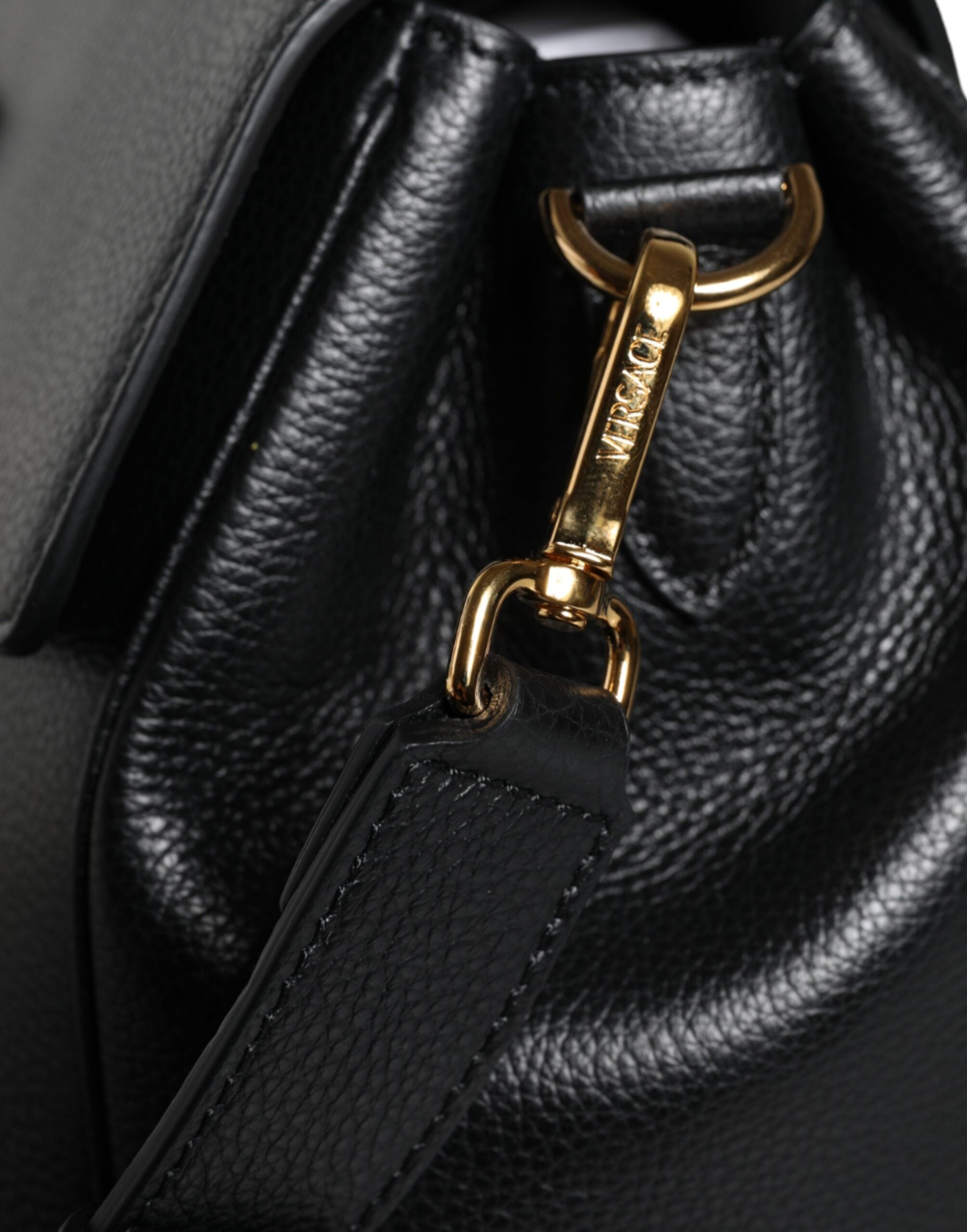 Black Top Handle Grainy Calfskin Leather Crossbody BagVERSACE Absolutely stunning, 100% Authentic, brand new with tags VERSACE bags. Brand logo, solid color, crossbody strap, magnetic fastening. Model: Crossbody bag Material: VL100%, CO100% Colour: Black