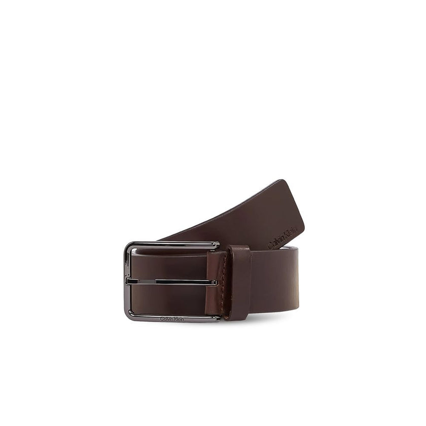Brown Leather BeltThe Calvin Klein WARMTH 40MM men’s belt, model K50K509759, is a refined accessory crafted from 100% premium leather. Featuring a rectangular polished metal buckle with engraved logo, this belt offers a minimalist and versatile design, pe