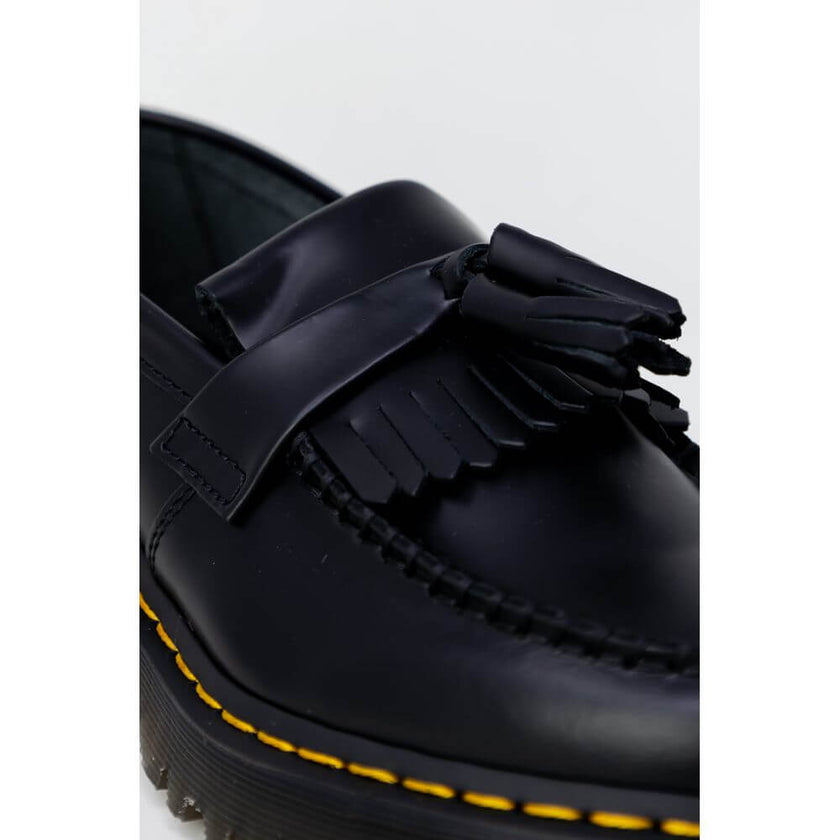 Black Leather Lace-Up BootsThe Dr. Martens Adrian Bex Smooth 26957001 women’s lace-up shoes are an icon of style and attitude. Crafted entirely from high-quality leather, these loafers feature a classic silhouette enhanced by distinctive details such as t