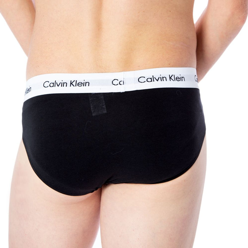 Black Cotton BriefsDiscover the comfort and timeless style of the Calvin Klein Underwear 3 Hip Brief U2661G men’s briefs. Made from a blend of 95% cotton and 5% stretch, these briefs provide a perfect fit and a soft feel against the skin. The elastic wais