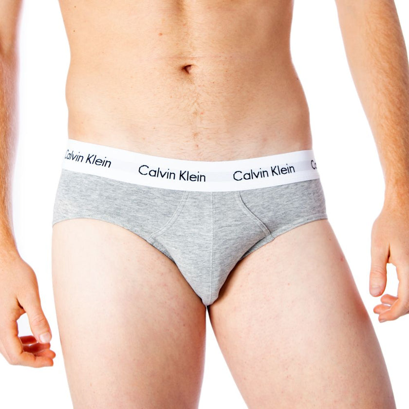 Gray Cotton BriefsDiscover the comfort and timeless style of the Calvin Klein Underwear 3 Hip Brief U2661G men’s briefs. Made from a blend of 95% cotton and 5% stretch, these briefs provide a perfect fit and a soft feel against the skin. The elastic waist