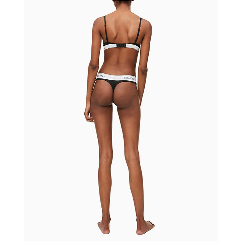 Black Cotton PantieDiscover timeless comfort and style with the Calvin Klein Underwear THONG F3786E. Made from a high-quality blend of 53% cotton, 35% Modal, and 12% elastane, this thong is designed to provide a perfect fit and a soft feel against the ski
