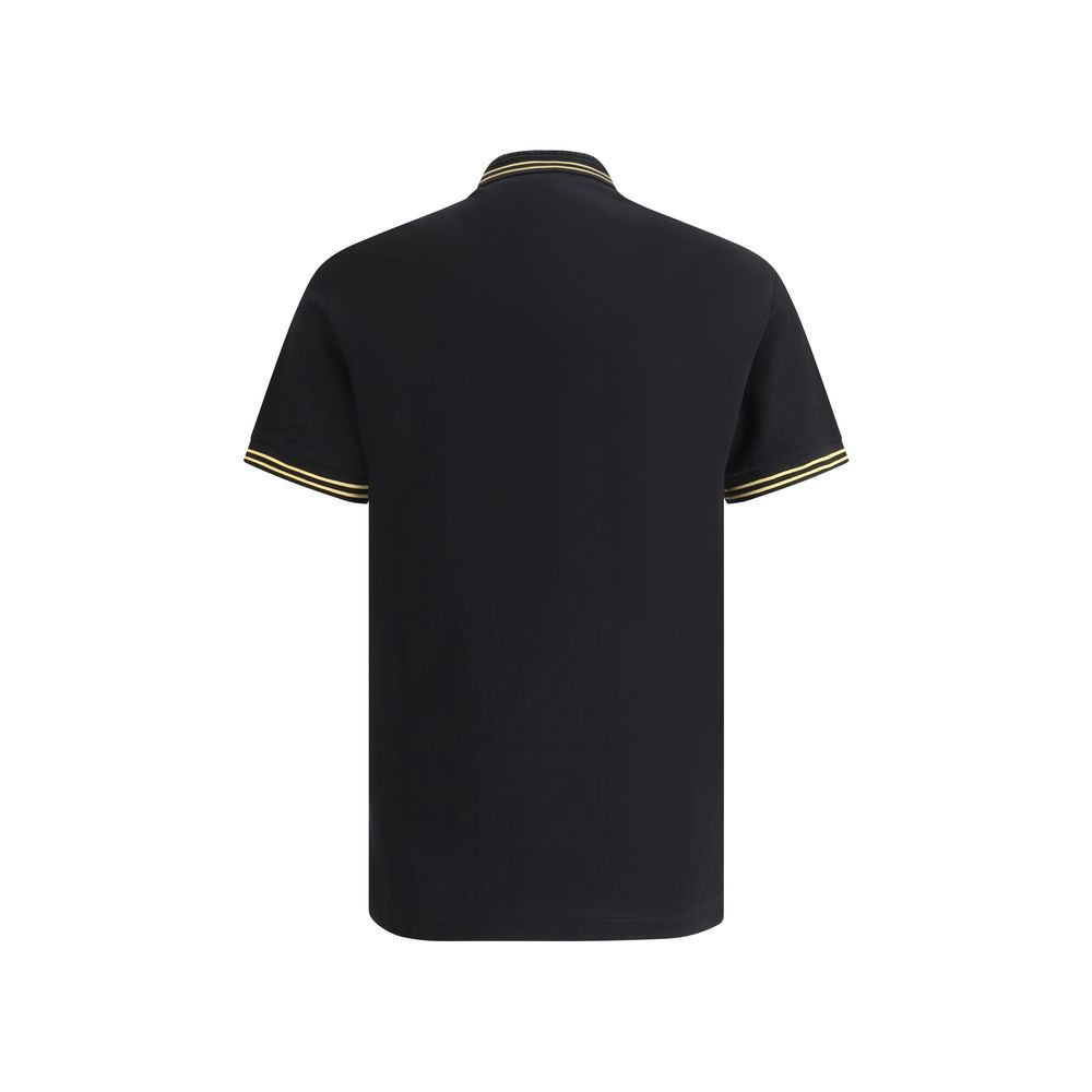 Black Cotton Polo ShirtCotton Polo Shirt by Versace, classic ribbed collar, tone-on-tone front buttons, iconic brand logo patch applied on front, regular fit. Season: AW25 Composition: 100% Cotton MADE IN TUNISIABlack Cotton Polo Shirt${tagsVersaceAulae B