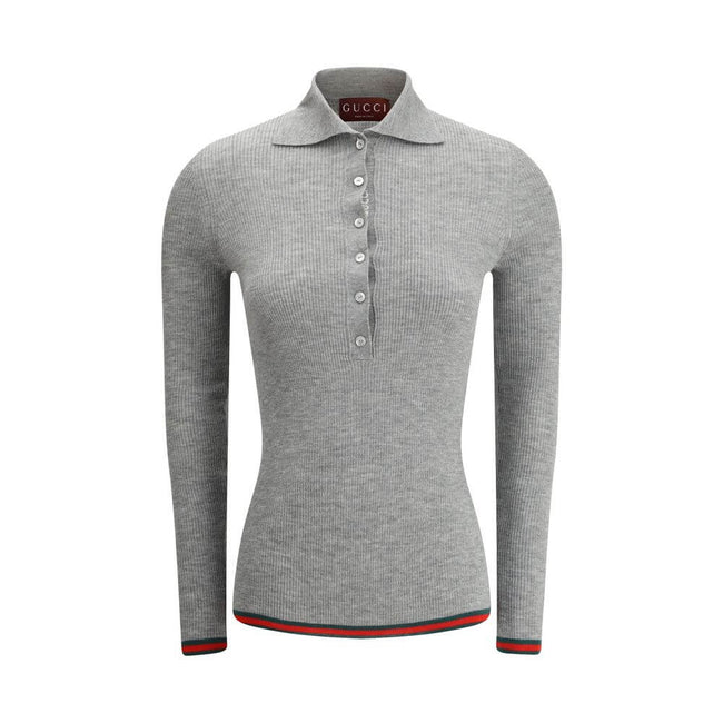 Gray Cashmere TopGucci’s Cashmere Polo Sweater is an elegant and sophisticated piece, crafted from soft cashmere for superior comfort. The long-sleeved style features a classic collar and tone-on-tone buttons on the front, adding an understated touch of s