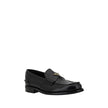 Black Calf Leather Bos Taurus Slip-On LoafersPrada’s leather Loafers are a mix of classic elegance and distinctive details. The slightly elongated round toe and leather block heel ensure comfort and style. The iconic enameled triangular plaque with the br