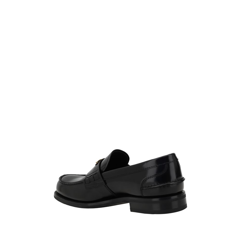 Black Calf Leather Bos Taurus Slip-On LoafersPrada’s leather Loafers are a mix of classic elegance and distinctive details. The slightly elongated round toe and leather block heel ensure comfort and style. The iconic enameled triangular plaque with the br