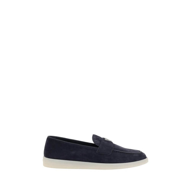 Blue Rubber Slip-On LoafersPrada’s leather Loafers feature an almond toe and a suede design that lends a touch of sophisticated elegance. The contrasting flat sole and front tray embellished with the brand’s iconic triangular plaque add a distinctive deta
