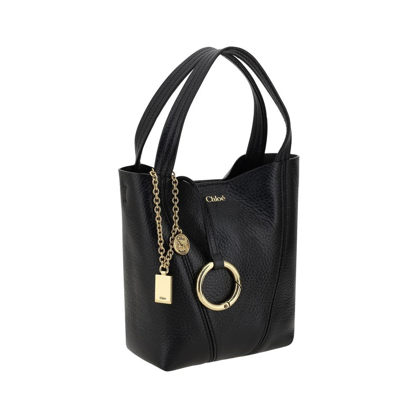 Black Calf Leather Bos Taurus Shoulder BagThe Spin Shoulder Bag by Chloé, crafted by shiny grained leather, features an elegant design with two flat top handles and an adjustable shoulder strap. The closure is secured by a magnetic button, while the detai