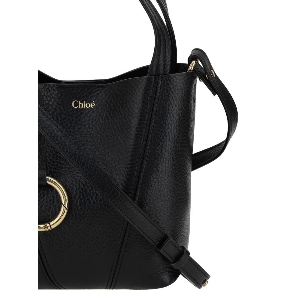 Black Calf Leather Bos Taurus Shoulder BagThe Spin Shoulder Bag by Chloé, crafted by shiny grained leather, features an elegant design with two flat top handles and an adjustable shoulder strap. The closure is secured by a magnetic button, while the detai