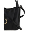 Black Calf Leather Bos Taurus Shoulder BagThe Spin Shoulder Bag by Chloé, crafted by shiny grained leather, features an elegant design with two flat top handles and an adjustable shoulder strap. The closure is secured by a magnetic button, while the detai