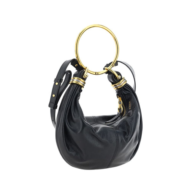 Black Calf Leather Bos Taurus HandbagLeather Bracelet Handbag by Chloé, a round brass handle, an adjustable flat shoulder strap and removable top zipper closure, single interior compartment. Season: AW25 Dimension: 32x32x10 Composition: 100% Calf Leather
