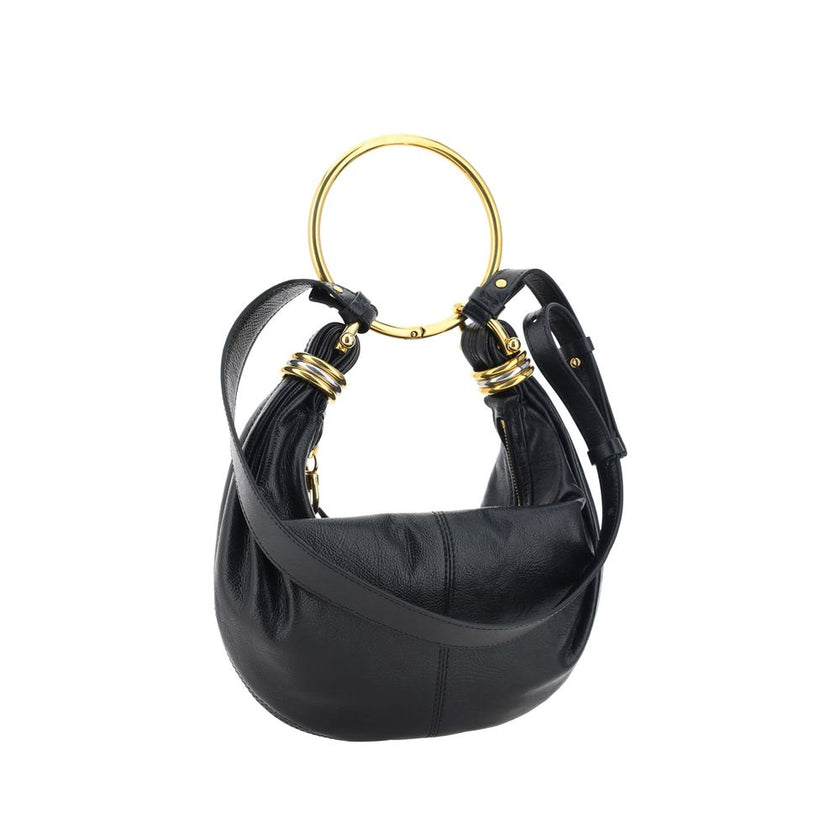 Black Calf Leather Bos Taurus HandbagLeather Bracelet Handbag by Chloé, a round brass handle, an adjustable flat shoulder strap and removable top zipper closure, single interior compartment. Season: AW25 Dimension: 32x32x10 Composition: 100% Calf Leather